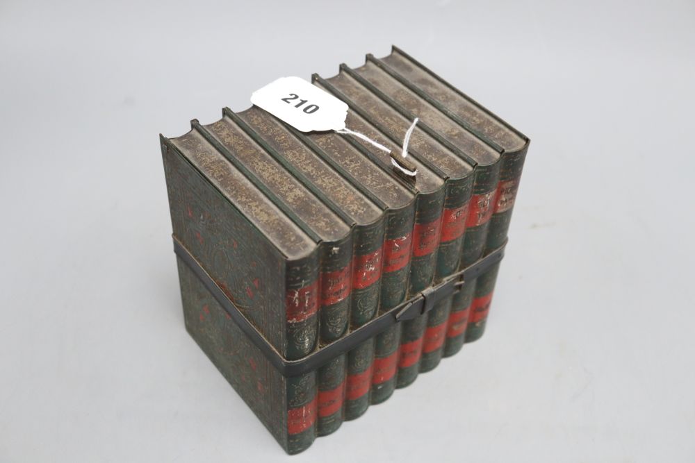 A biscuit tin in the form of eight leather bound Old Curiosity Shop books, (Huntley and Palmer), height 16cm